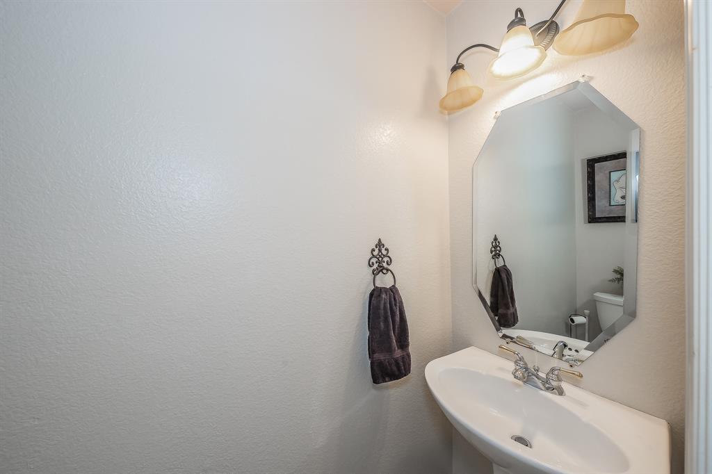 4425 Maple Shade Avenue Sachse, TX 75048 - Photo 36 of 40 a bathroom with a sink and a mirror