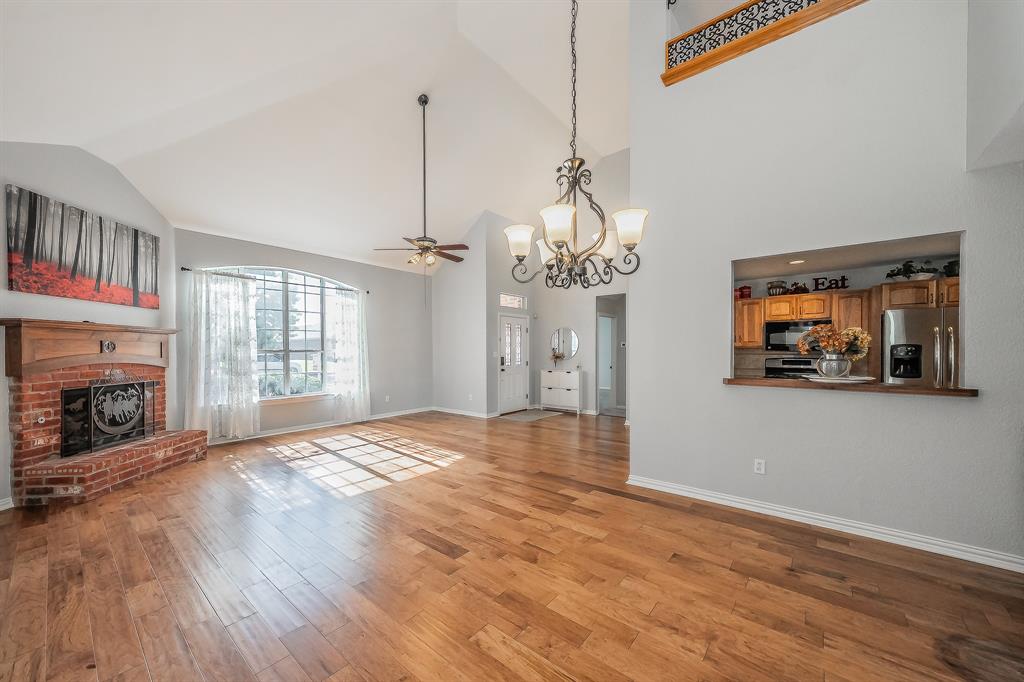 4425 Maple Shade Avenue Sachse, TX 75048 - Photo 7 of 40 a view of empty room with fireplace and wooden floor