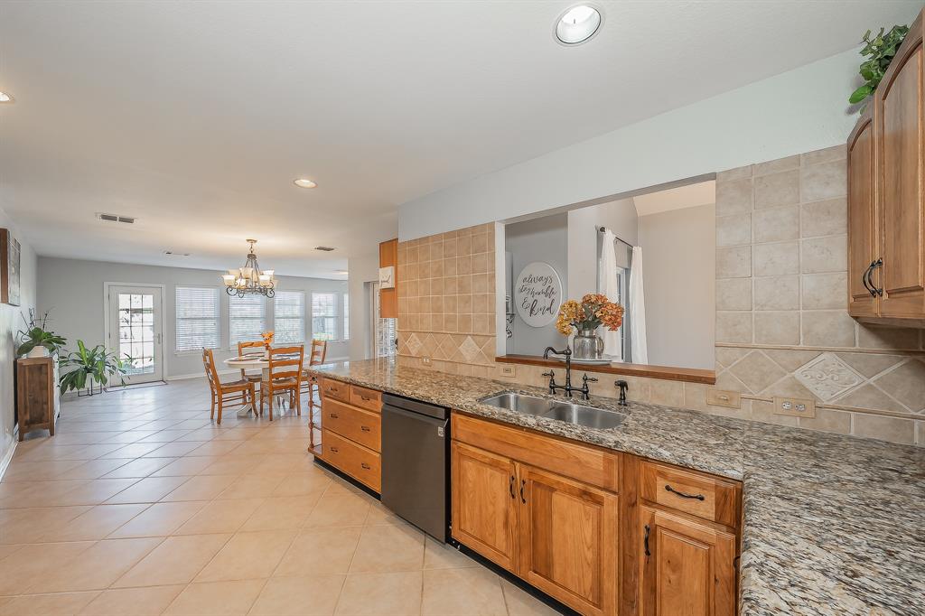 4425 Maple Shade Avenue Sachse, TX 75048 - Photo 9 of 40 a large living room with stainless steel appliances granite countertop a sink and a granite counter tops