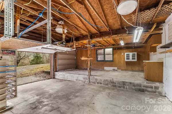 a view of empty room with wooden ceiling