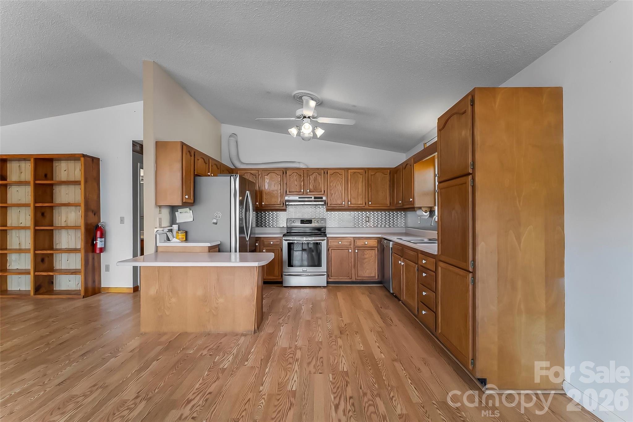 350 Sandy Bottom Road Marshall, NC 28753 - Photo 5 of 40 a large kitchen with a lot of counter space and a wooden floor