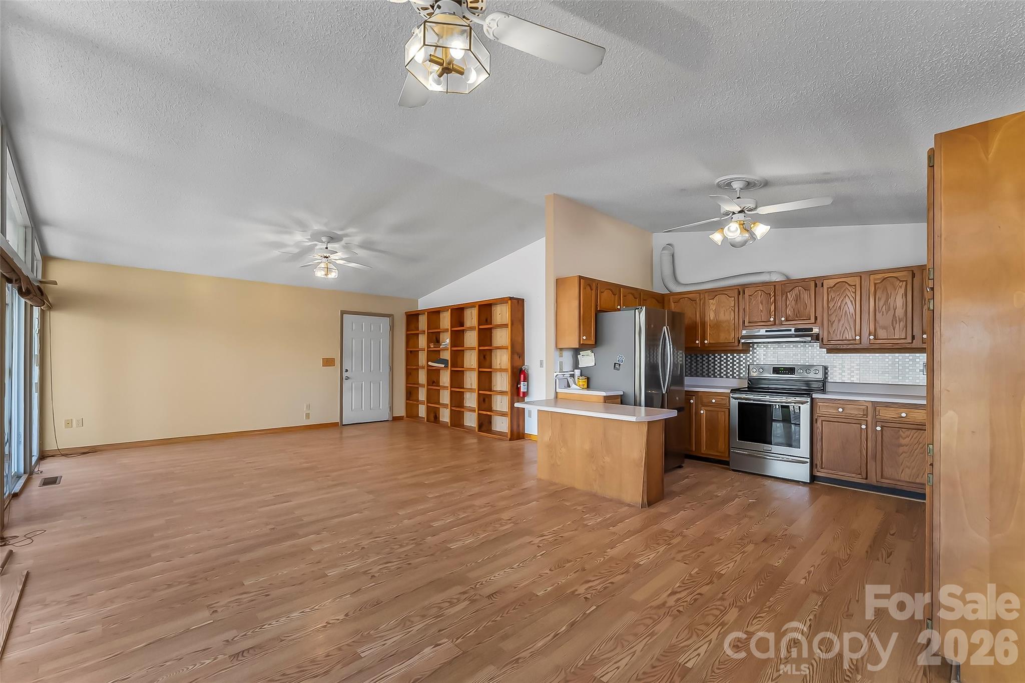 350 Sandy Bottom Road Marshall, NC 28753 - Photo 6 of 40 a large kitchen with cabinets wooden floor and stainless steel appliances