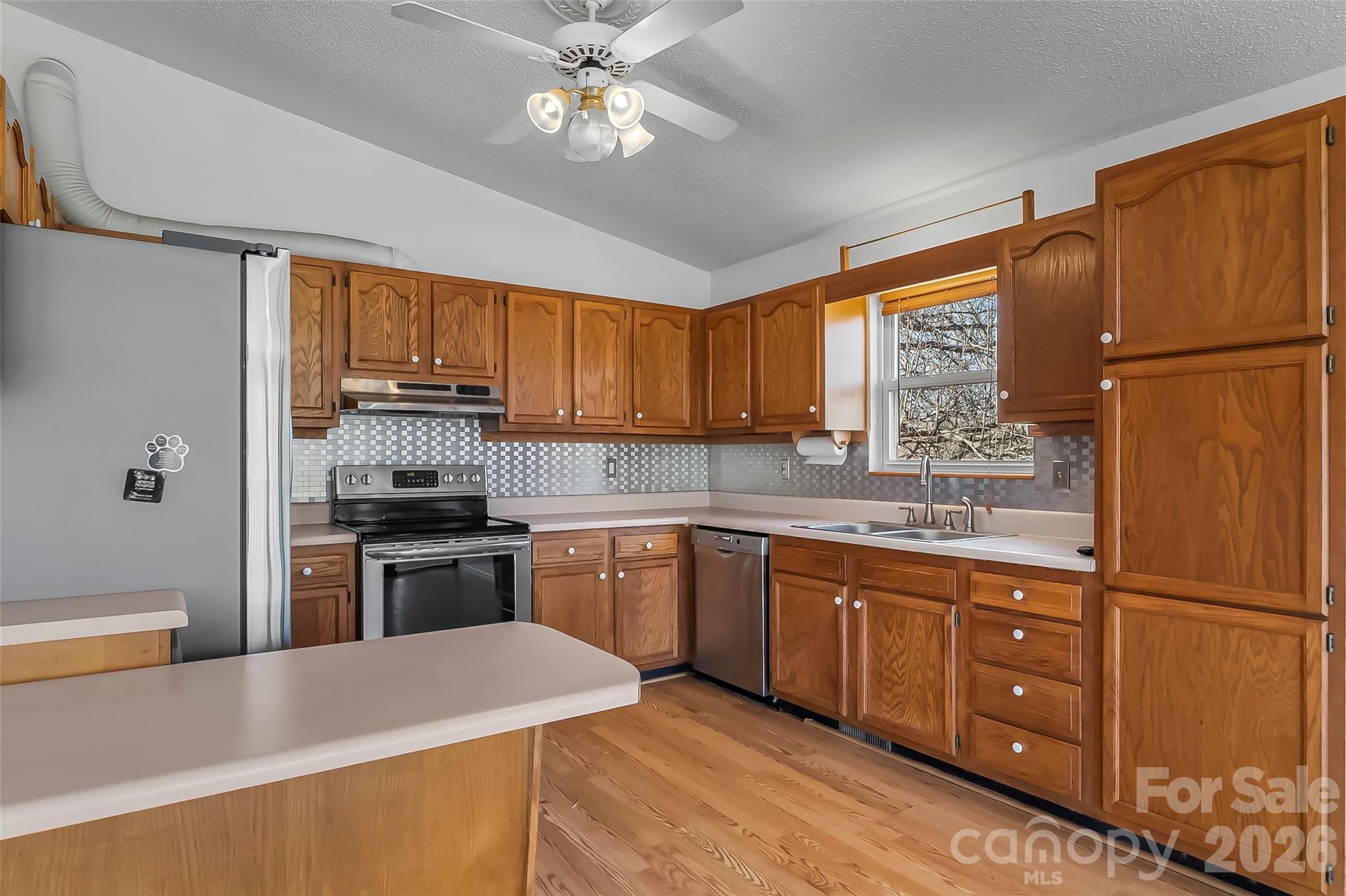 350 Sandy Bottom Road Marshall, NC 28753 - Photo 7 of 40 a kitchen with stainless steel appliances granite countertop a refrigerator a stove a sink dishwasher and a refrigerator
