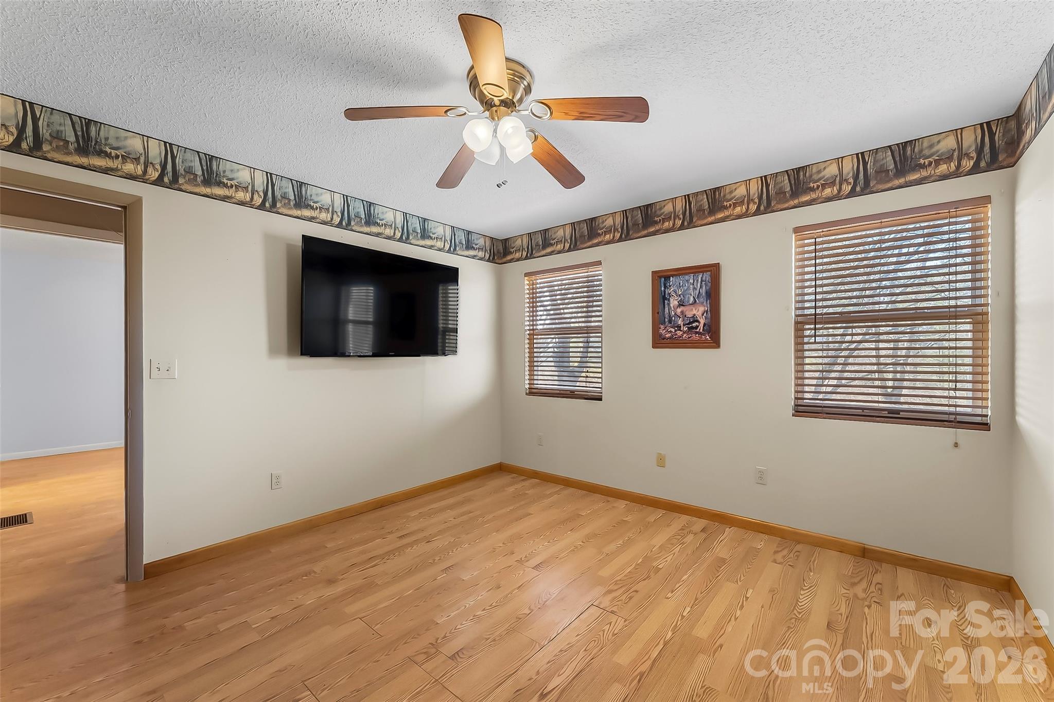 350 Sandy Bottom Road Marshall, NC 28753 - Photo 10 of 40 a view of an empty room with wooden floor and a window