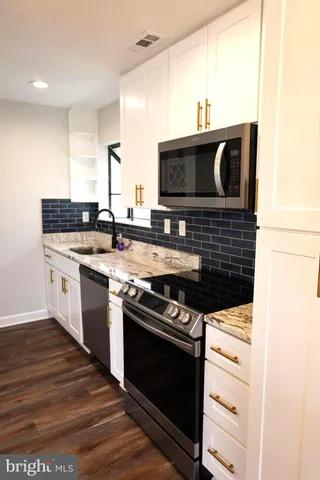 a kitchen with a stove and a microwave