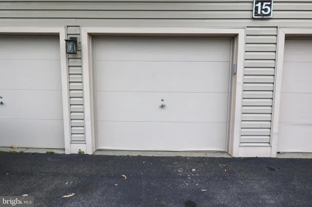 a view of a house with a yard and wooden fence
