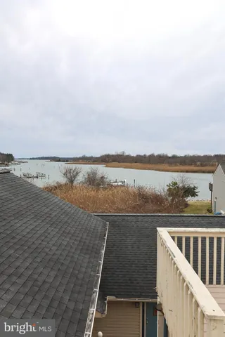 a view of a roof deck with large ocean