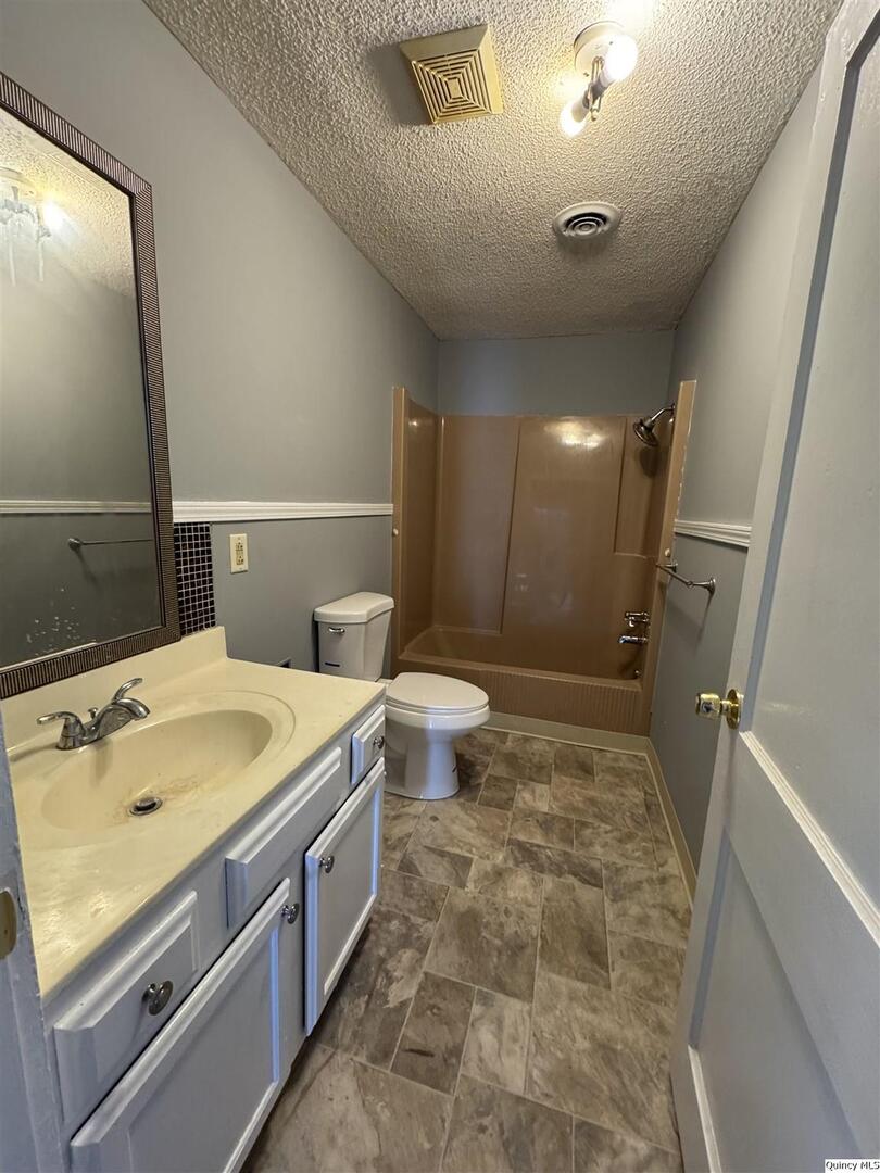 605 Adams Street Quincy, IL 62301 - Photo 12 of 15 a bathroom with a sink and mirror