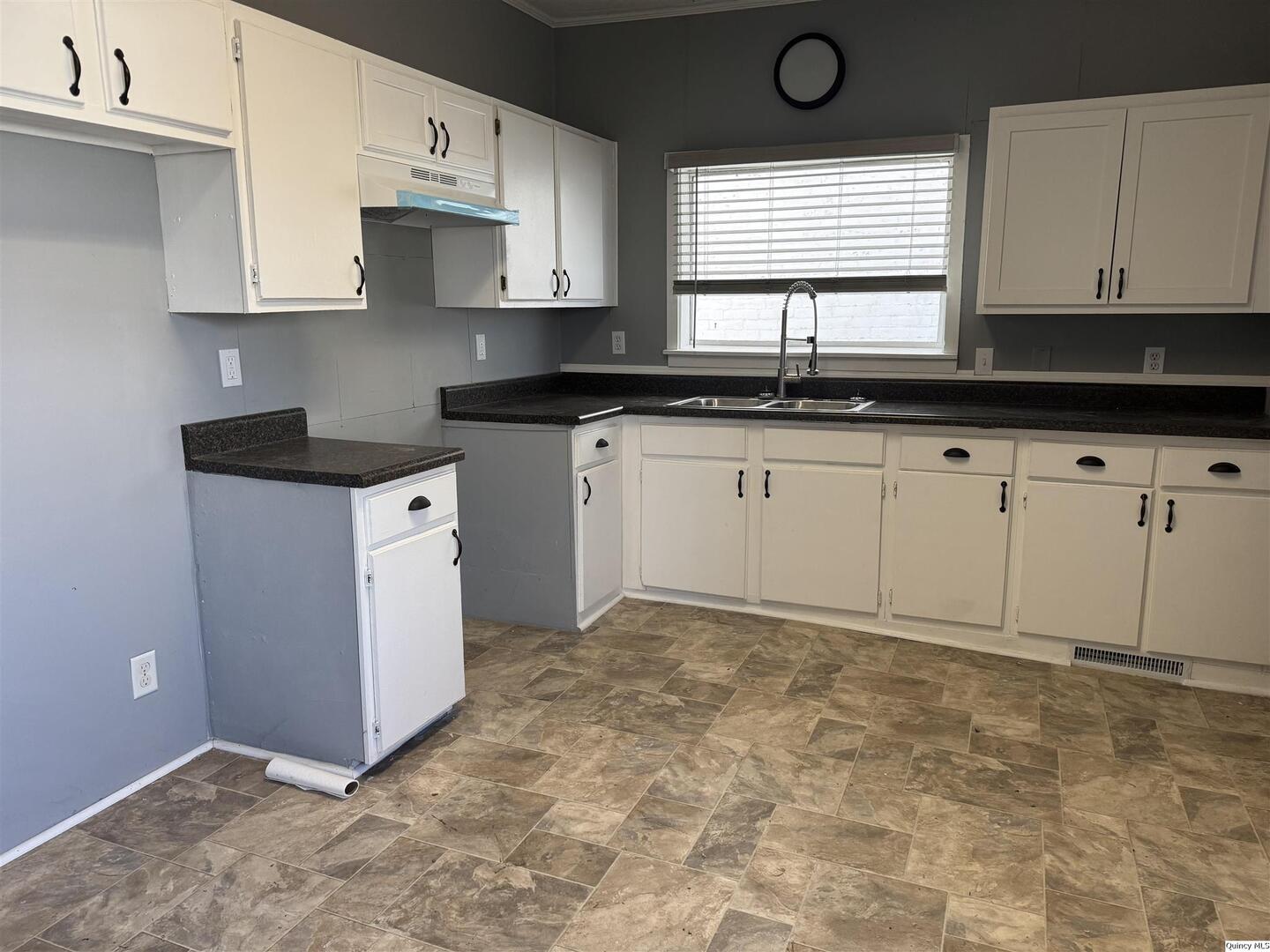 605 Adams Street Quincy, IL 62301 - Photo 2 of 15 a kitchen with granite countertop a sink a stove a microwave and cabinets