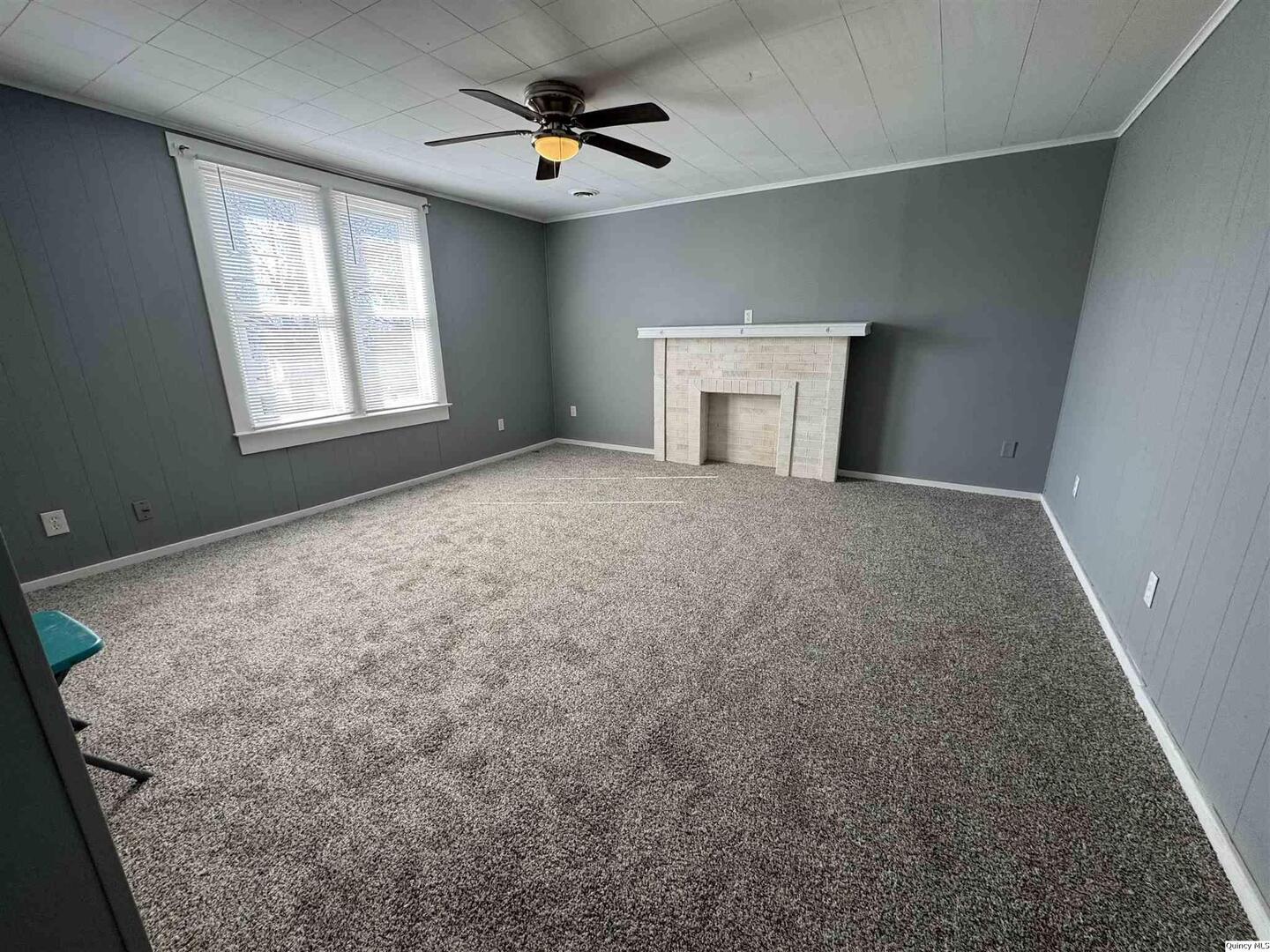 605 Adams Street Quincy, IL 62301 - Photo 6 of 15 an empty room with windows and fireplace