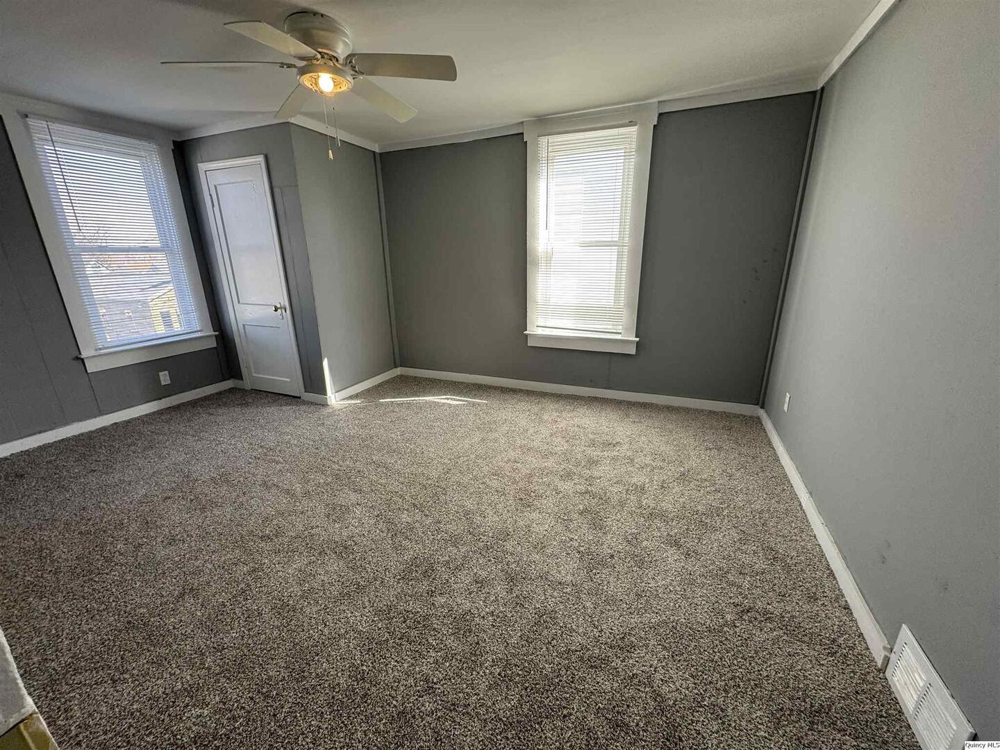 605 Adams Street Quincy, IL 62301 - Photo 7 of 15 an empty room with windows and fan