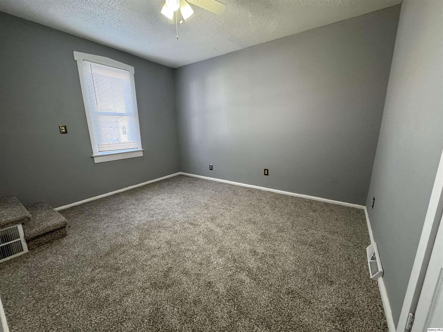 605 Adams Street Quincy, IL 62301 - Photo 9 of 15 an empty room with windows and closet