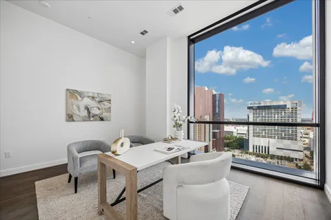 a balcony with furniture and large windows