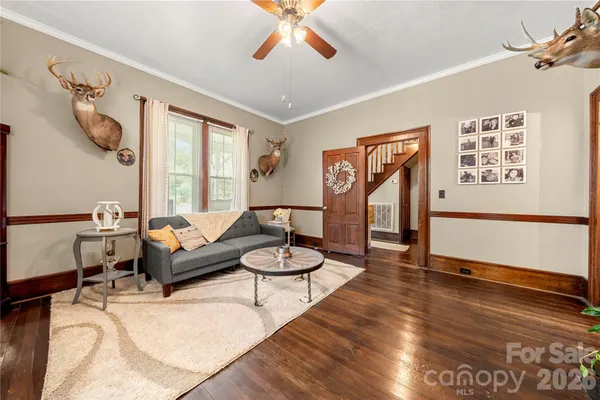 a living room with furniture and a wooden floor