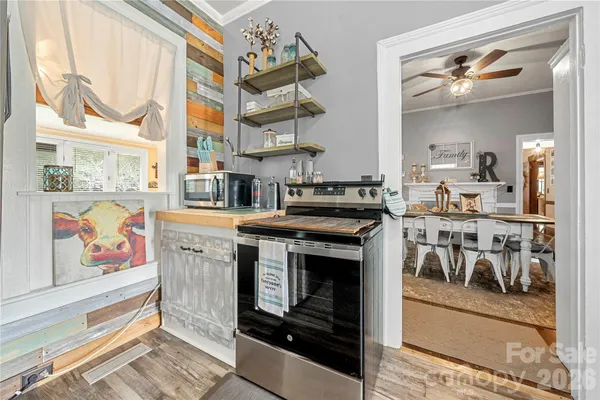 a kitchen with a sink cabinets and wooden floor