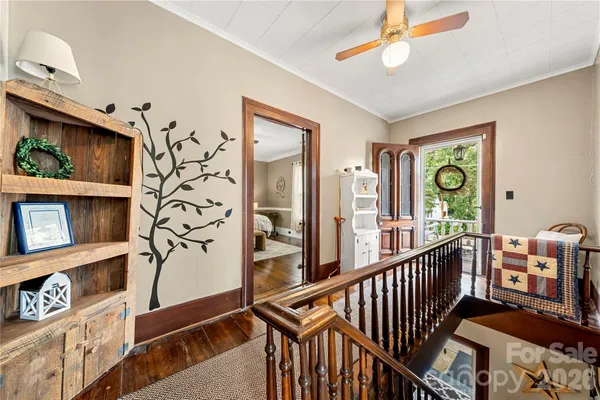 a bedroom with a bed wooden floor and window
