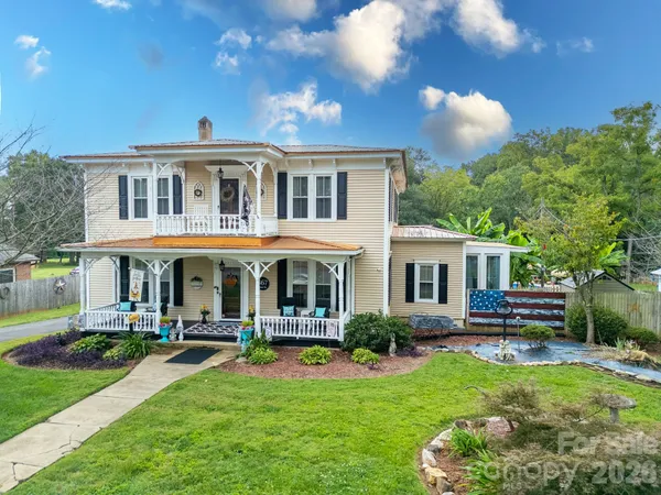 a view of house with a yard chairs and table in a patio