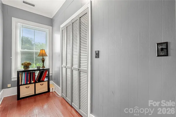 a garden with a fountain in front of the house