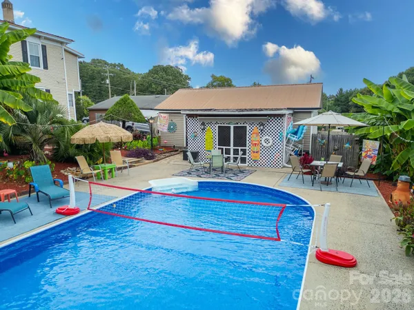 a swimming pool with outdoor seating