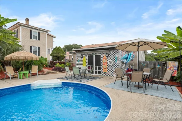 a swimming pool with outdoor seating and yard
