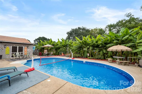 an outdoor space with swimming pool and furniture
