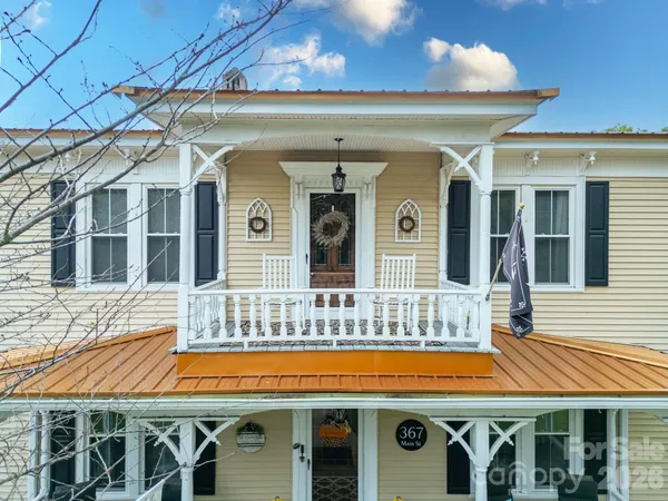 a view of a house with a yard porch and sitting area