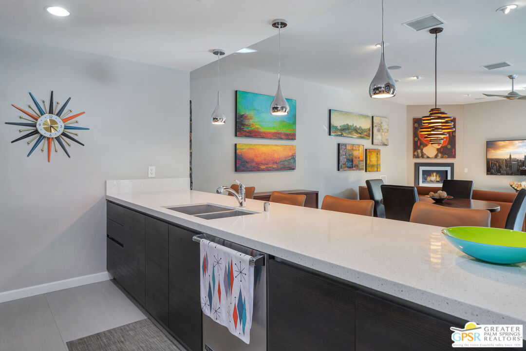 1069 Dane Drive Palm Springs, CA 92262 - Photo 36 of 51 a living room with stainless steel appliances kitchen island a table and chairs in it