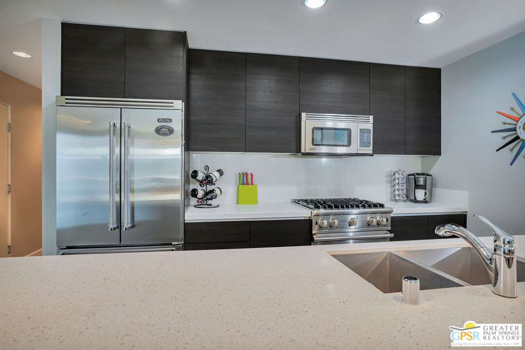 1069 Dane Drive Palm Springs, CA 92262 - Photo 37 of 51 a kitchen with stainless steel appliances granite countertop a refrigerator and a sink