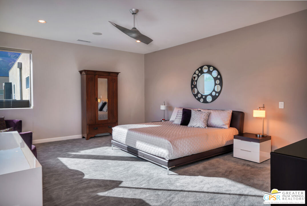 1069 Dane Drive Palm Springs, CA 92262 - Photo 39 of 51 a bedroom with a bed and a chandelier