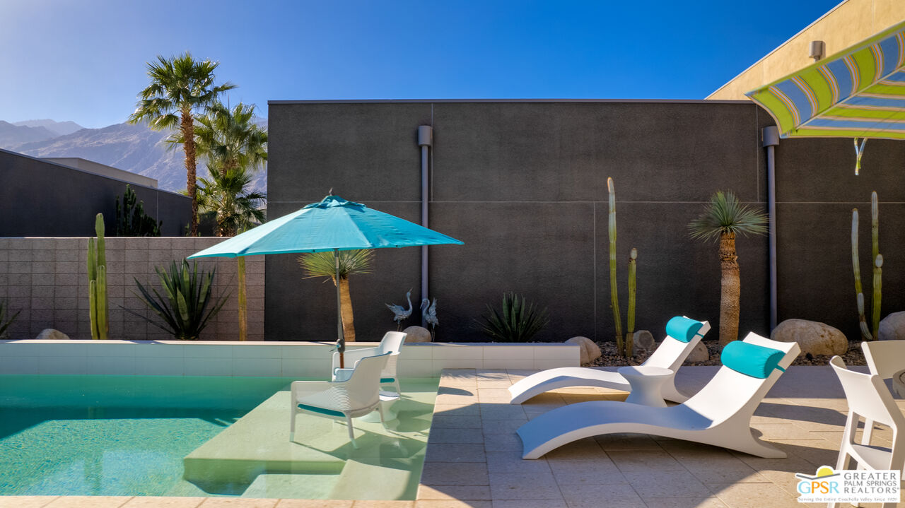 1069 Dane Drive Palm Springs, CA 92262 - Photo 4 of 51 a backyard of a house with table and chairs