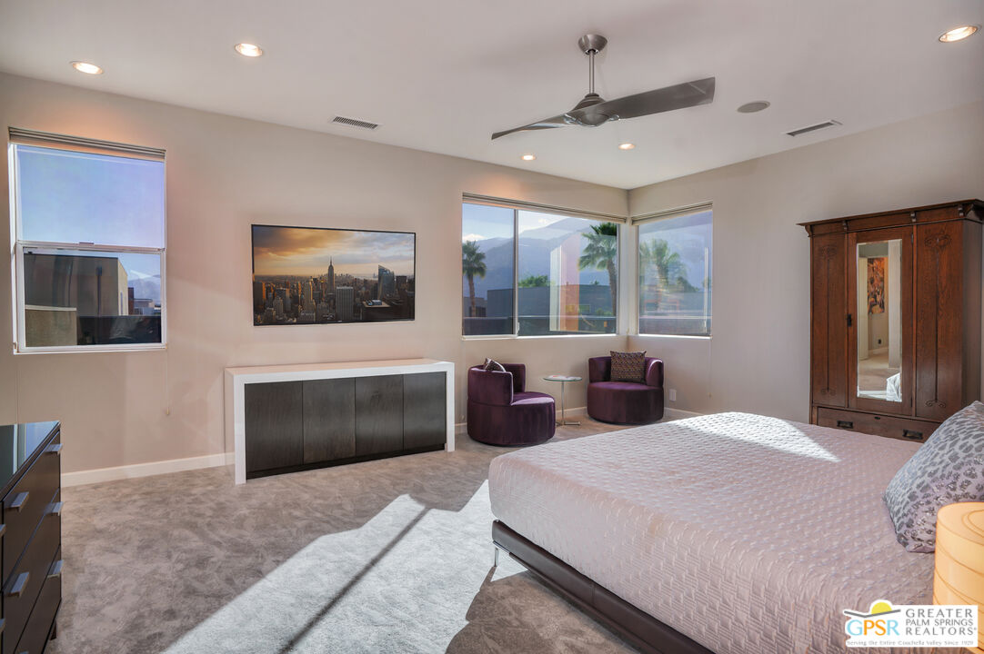 1069 Dane Drive Palm Springs, CA 92262 - Photo 41 of 51 a bedroom with a large bed and a flat screen tv