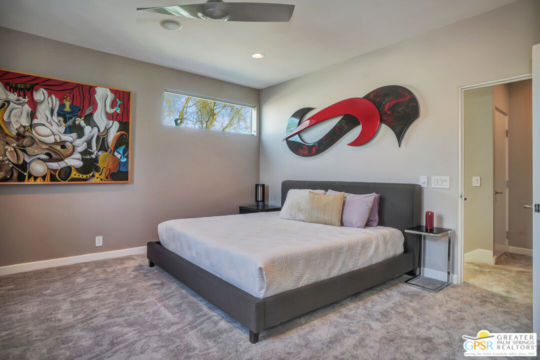 1069 Dane Drive Palm Springs, CA 92262 - Photo 45 of 51 a bedroom with a bed and painting on the wall