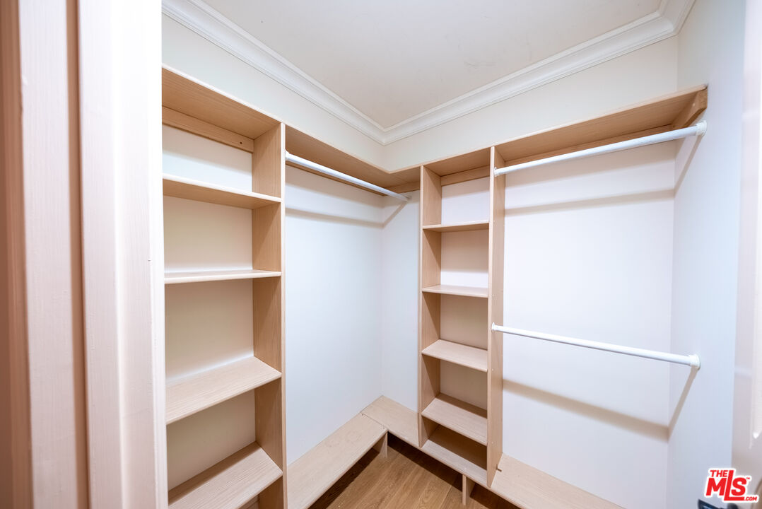 13847 Gilmore Street Van Nuys, CA 91401 - Photo 13 of 43 a view of walk in closet with empty racks