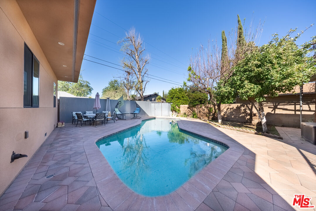 13847 Gilmore Street Van Nuys, CA 91401 - Photo 21 of 43 a view of a swimming pool with sitting area