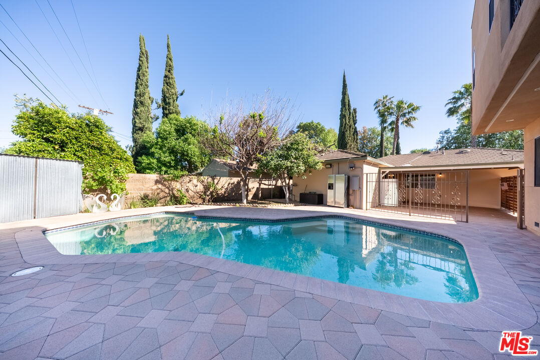 13847 Gilmore Street Van Nuys, CA 91401 - Photo 22 of 43 a view of a swimming pool with a patio