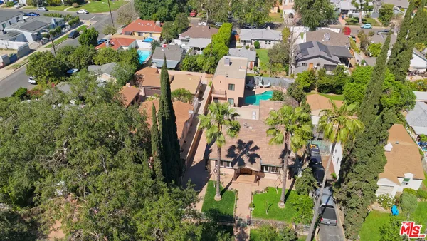 an aerial view of residential houses with outdoor space