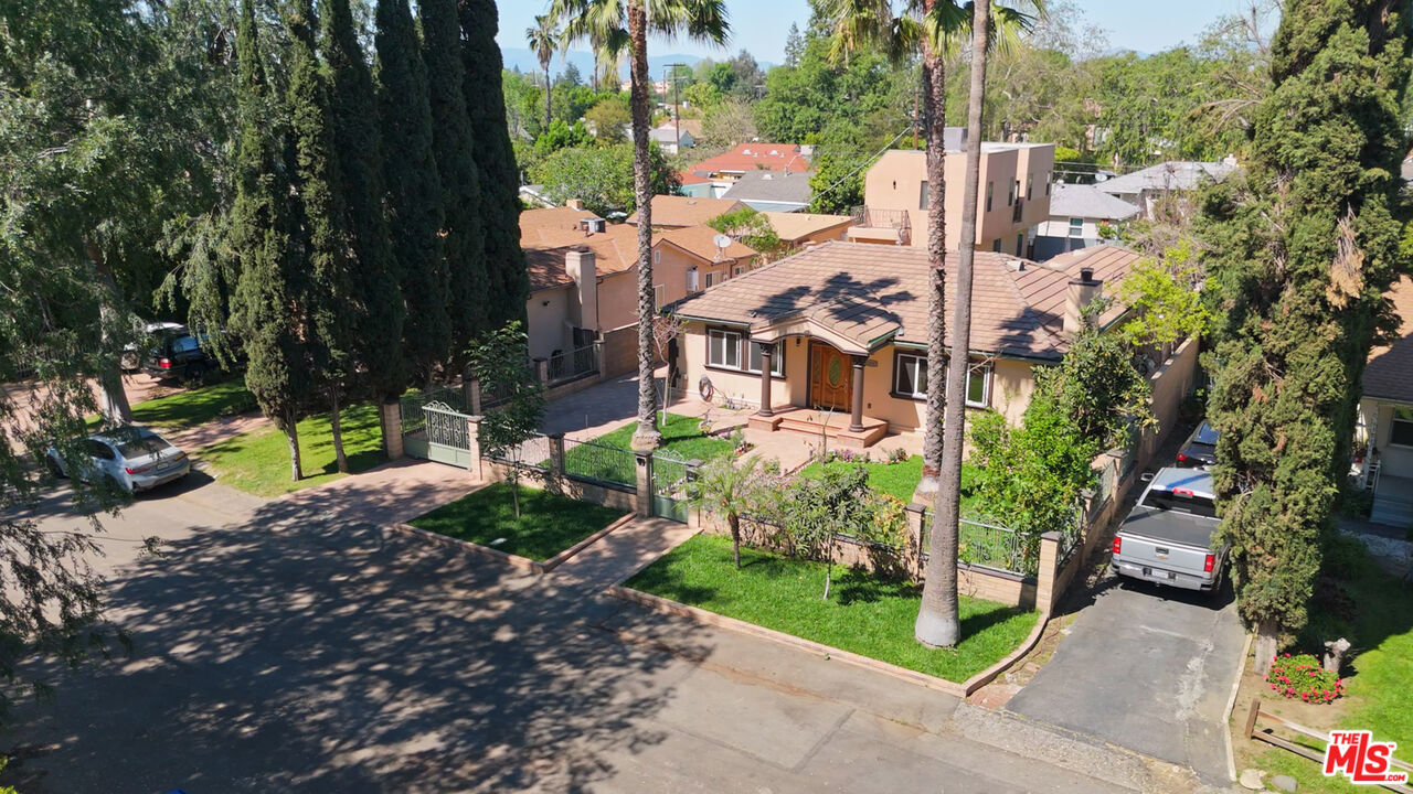 13847 Gilmore Street Van Nuys, CA 91401 - Photo 29 of 43 a view of a city with flower plants and wooden fence