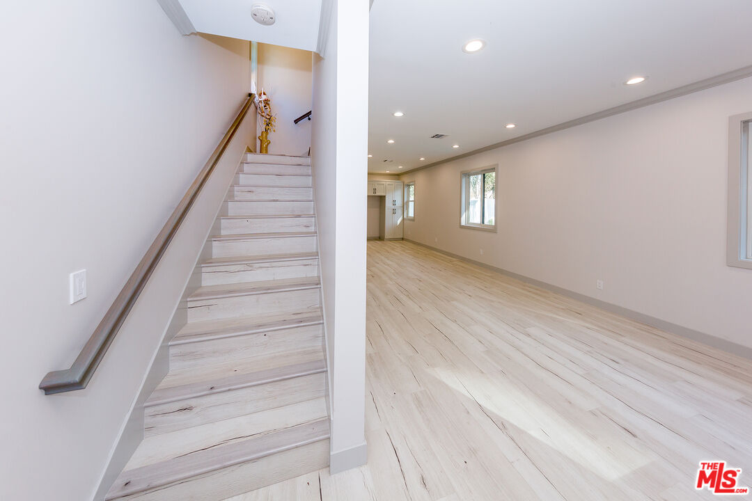 13847 Gilmore Street Van Nuys, CA 91401 - Photo 33 of 43 a view of staircase with white walls and windows