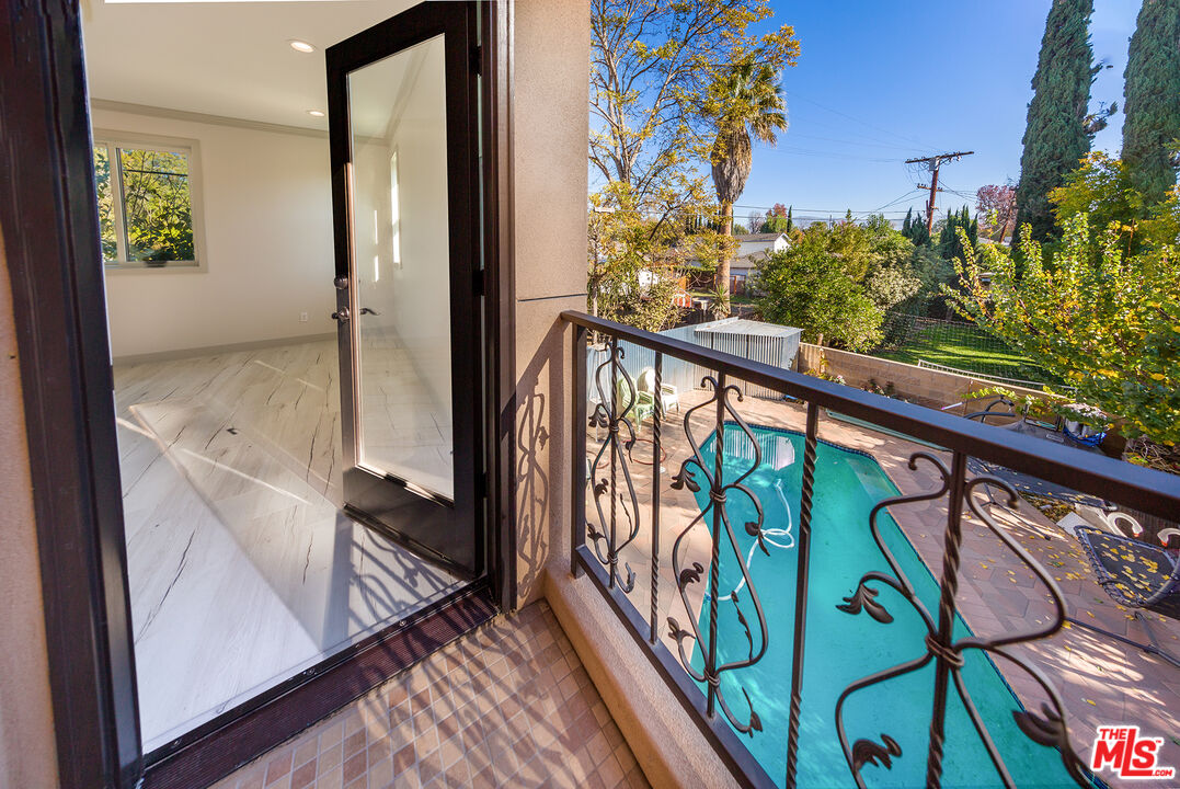 13847 Gilmore Street Van Nuys, CA 91401 - Photo 39 of 43 a view of a balcony with wooden floor and stairs