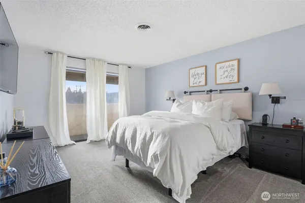 a spacious bedroom with a bed and a couch