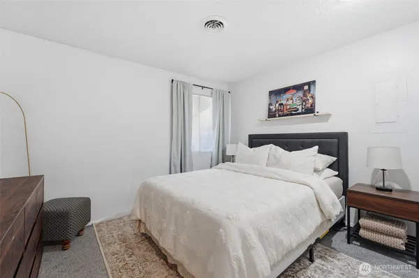 a bedroom with a bed and a couch