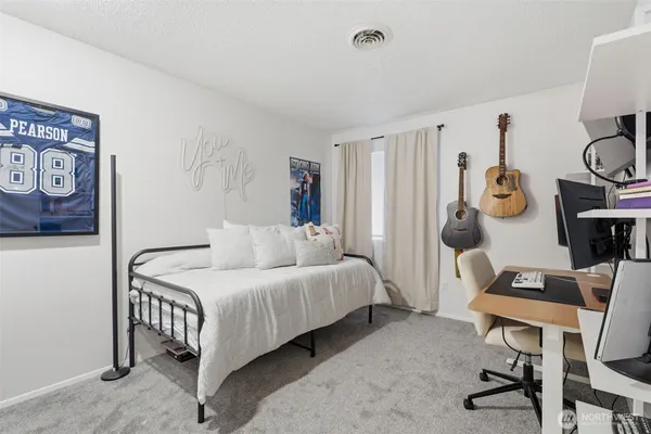 a bedroom with a bed a desk and chair