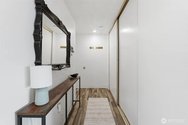 a view of a hallway with wooden floor and staircase