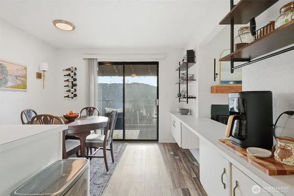 a view of a workspace with furniture and a window