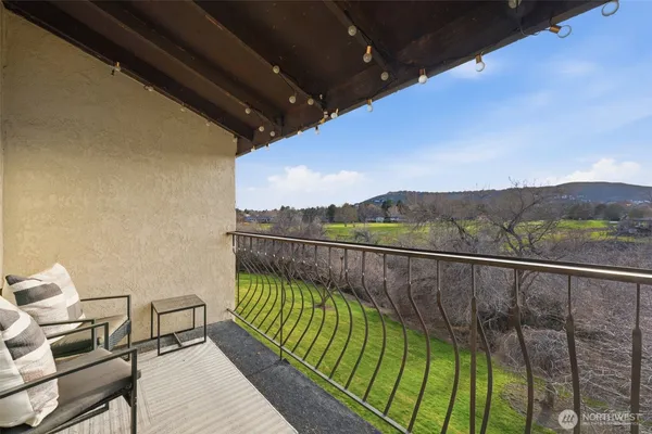 a view of balcony with furniture