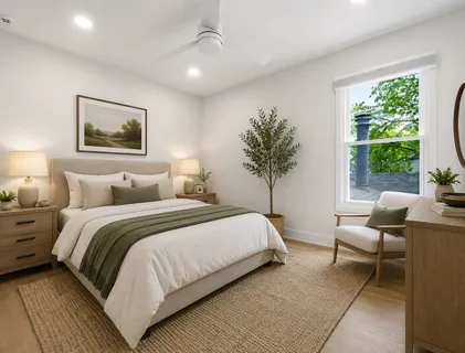 a bedroom with bed and large windows