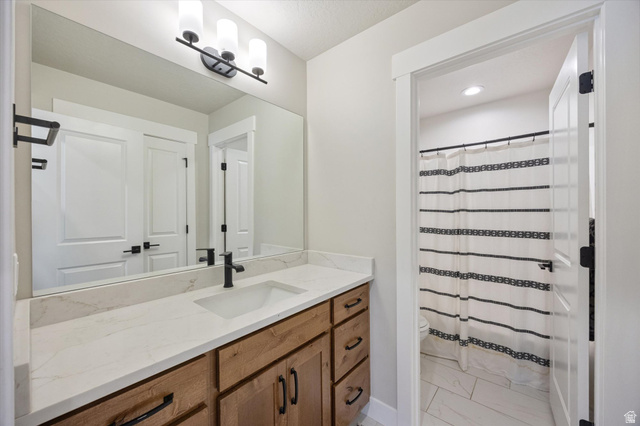 754 West 400 North, Unit 29 Mapleton, UT 84664 - Photo 18 of 25 Bathroom featuring curtained shower, vanity, light marble finish floors, and recessed lighting