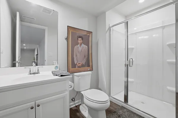 a bathroom with a sink toilet vanity and shower