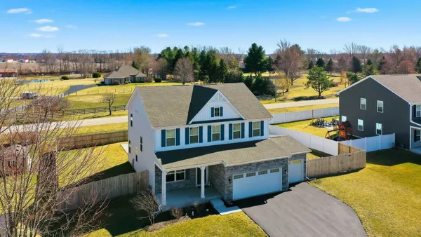 a view of a house with pool and chairs