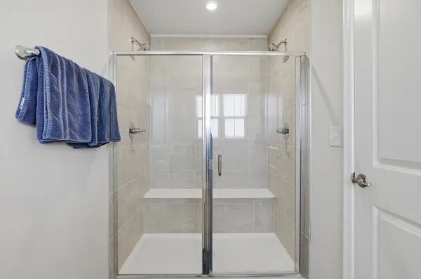 a bathroom with a shower and a glass door